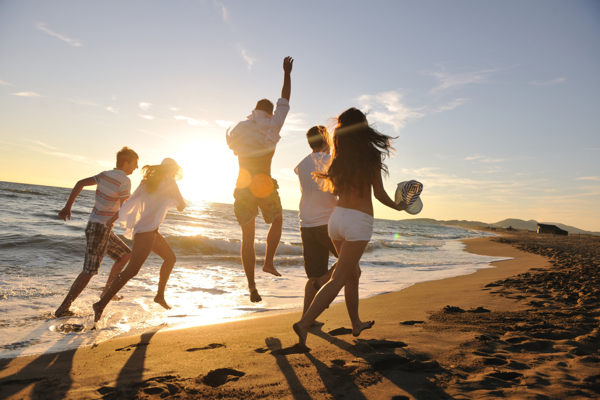 People Group Running on the Beach